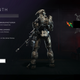 A Spartan holds a sniper rifle in Halo Infinite while viewing the Juneteenth emblem.
